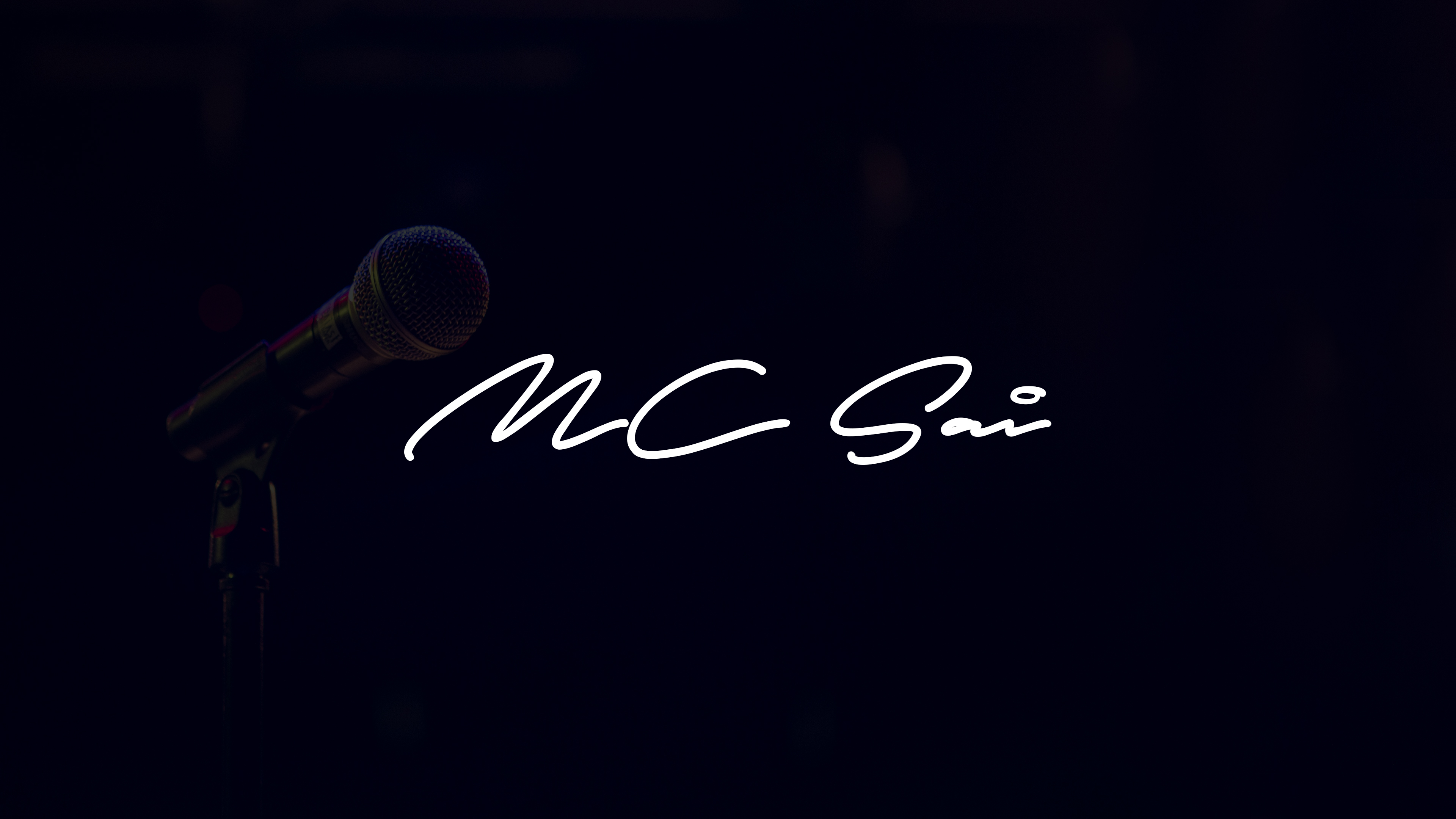 MC Sai — microphone against a cinematic dark backdrop